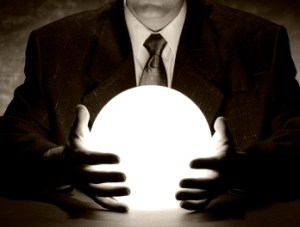 A businessman is consulting a crystal ball to foretell the future.