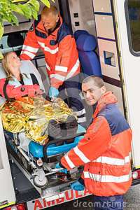 paramedics-helping-woman-stretcher-ambulance-26904398